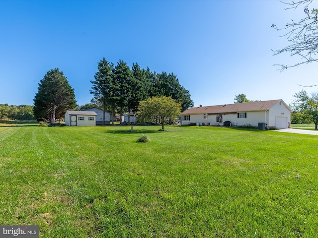 view of yard with a garage and a storage shed