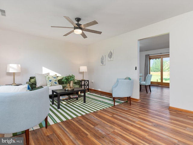 living room with wood-type flooring and ceiling fan