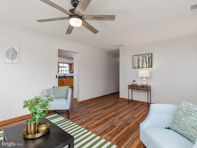 living room with ceiling fan, dark wood-type flooring, and sink