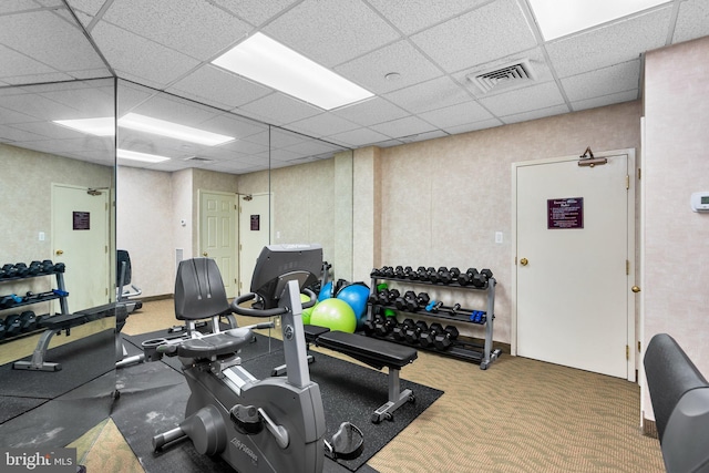 gym featuring carpet floors and a paneled ceiling