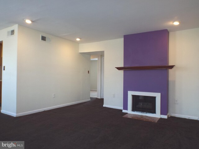 unfurnished living room featuring a fireplace with flush hearth, baseboards, visible vents, and recessed lighting
