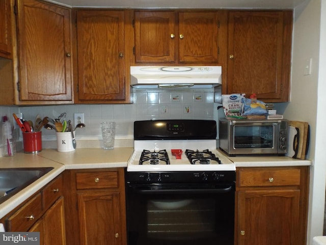 kitchen with white range with gas stovetop and backsplash