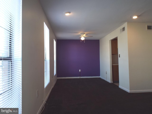 empty room featuring visible vents, baseboards, and a ceiling fan