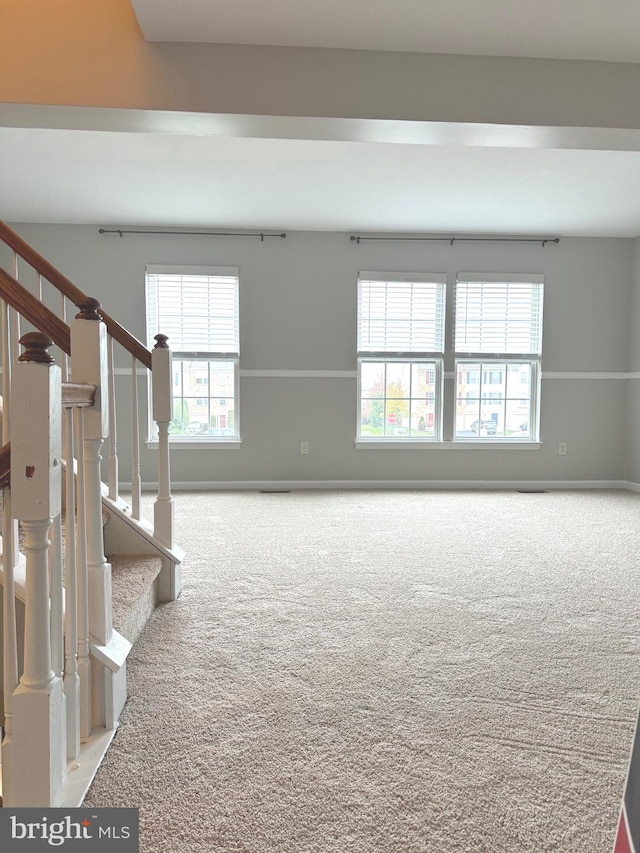 spare room with light colored carpet and plenty of natural light