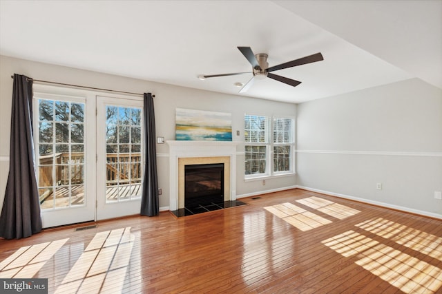 unfurnished living room with light hardwood / wood-style floors, plenty of natural light, and ceiling fan