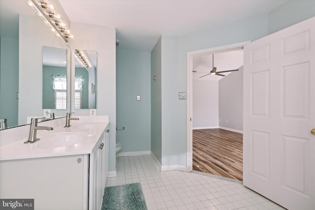 bathroom with hardwood / wood-style floors, ceiling fan, toilet, and vanity