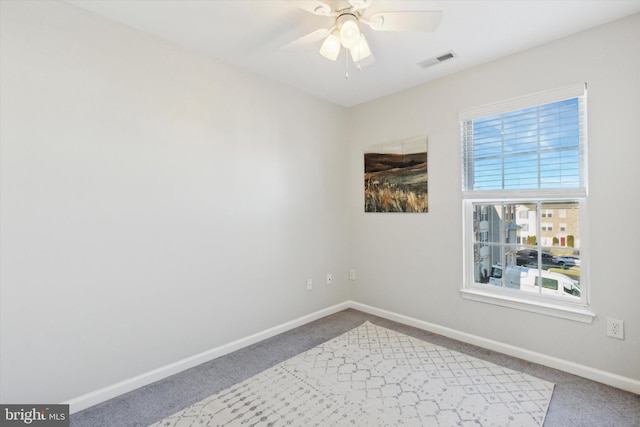 spare room with ceiling fan and carpet