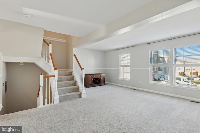 unfurnished living room featuring light carpet