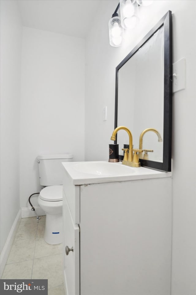 bathroom featuring tile patterned floors, vanity, and toilet