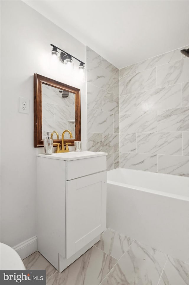 bathroom with vanity and tiled shower / bath