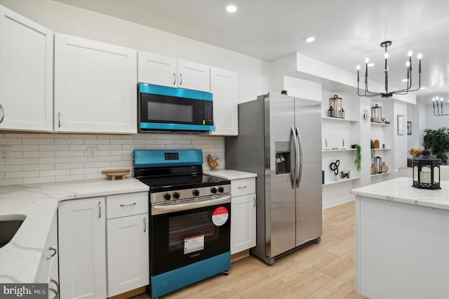 kitchen with white cabinets, stainless steel appliances, and light wood-type flooring