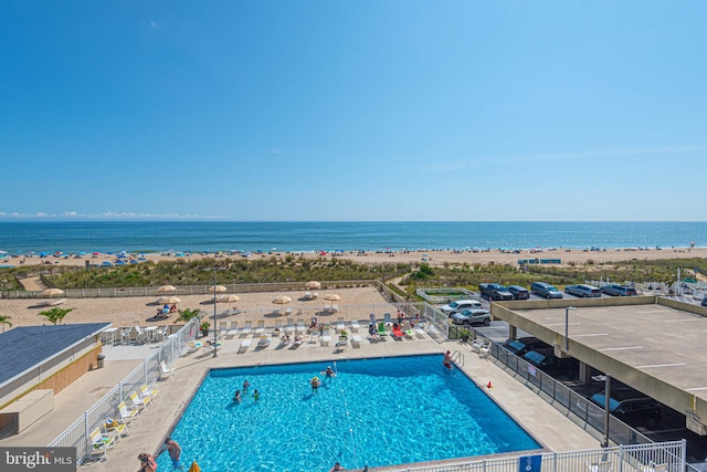 view of swimming pool with a patio and a water view