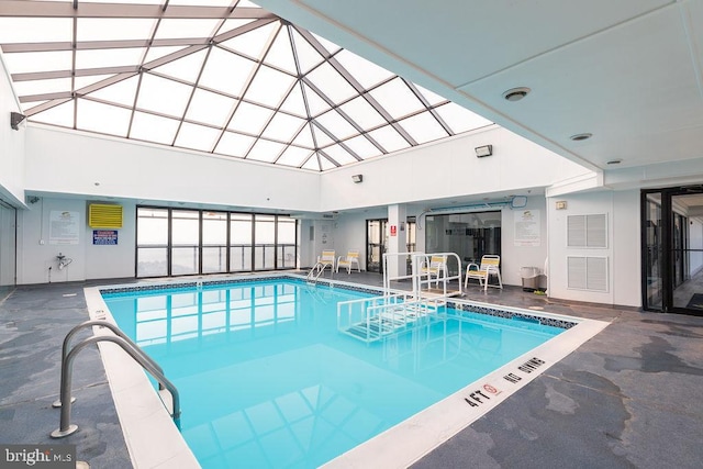 view of swimming pool featuring a skylight