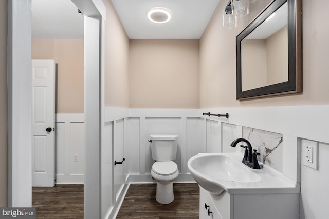 bathroom featuring vanity, toilet, and hardwood / wood-style flooring