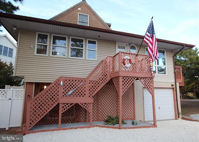 rear view of house featuring a garage