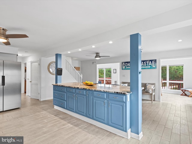 kitchen featuring blue cabinetry, light hardwood / wood-style floors, and built in fridge