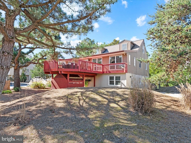 back of house featuring a deck