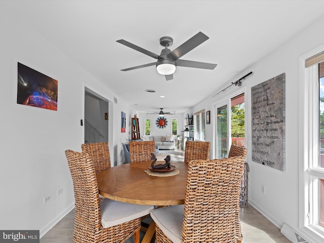 dining space featuring ceiling fan and hardwood / wood-style floors