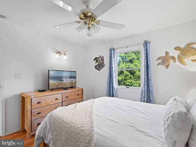 bedroom with ceiling fan and light hardwood / wood-style flooring