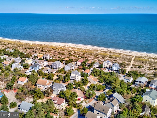 drone / aerial view with a water view and a beach view