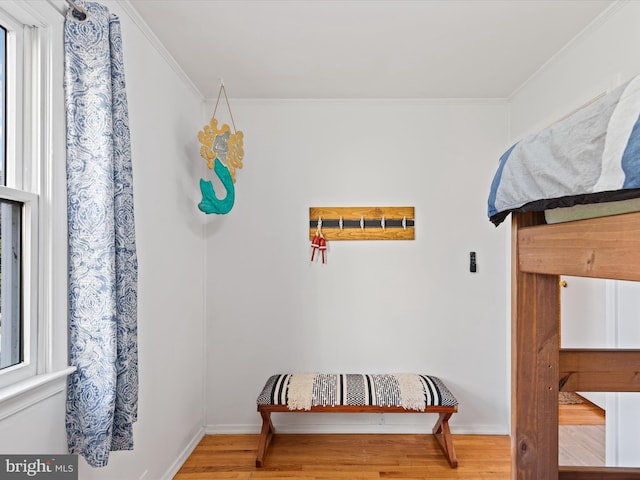 bedroom with wood-type flooring and ornamental molding