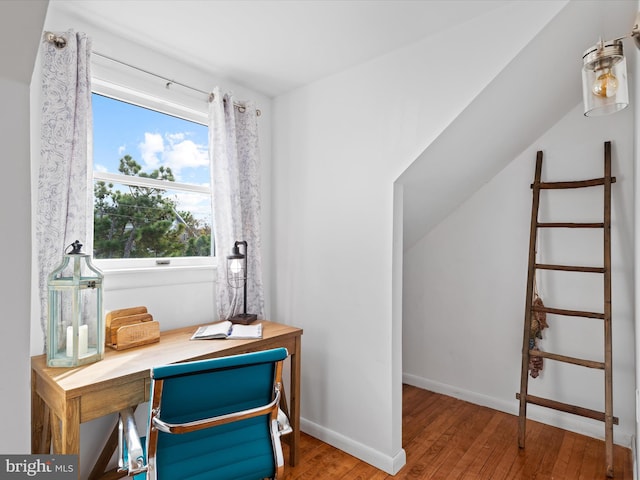 office space with built in desk and wood-type flooring