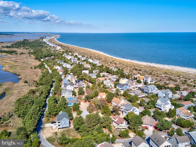 drone / aerial view featuring a water view and a view of the beach