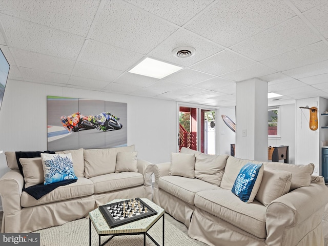 living room with a drop ceiling