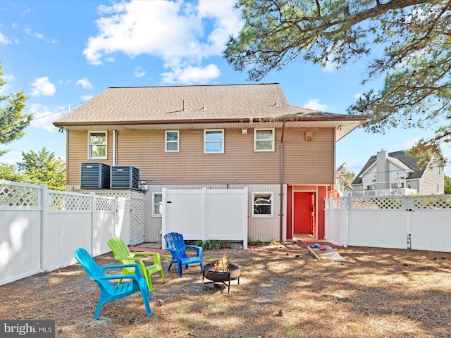 back of property with a fire pit