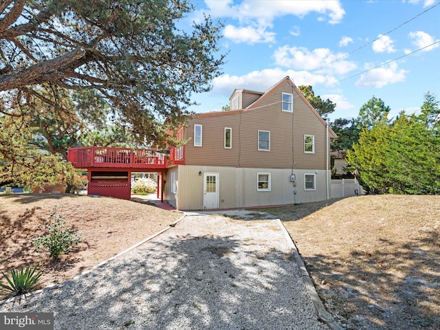 back of property featuring a wooden deck