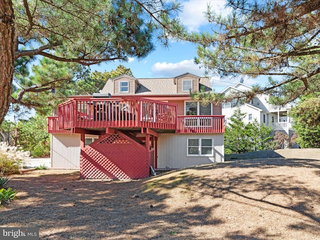 back of property with a wooden deck