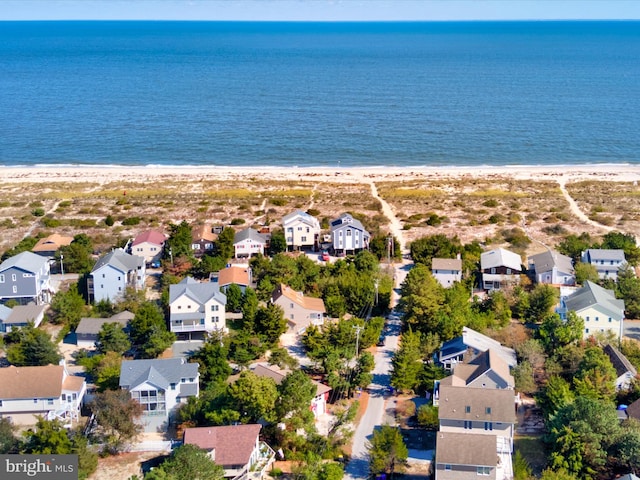 drone / aerial view featuring a beach view and a water view