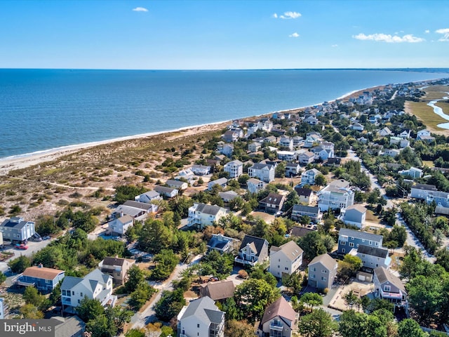 drone / aerial view with a beach view and a water view