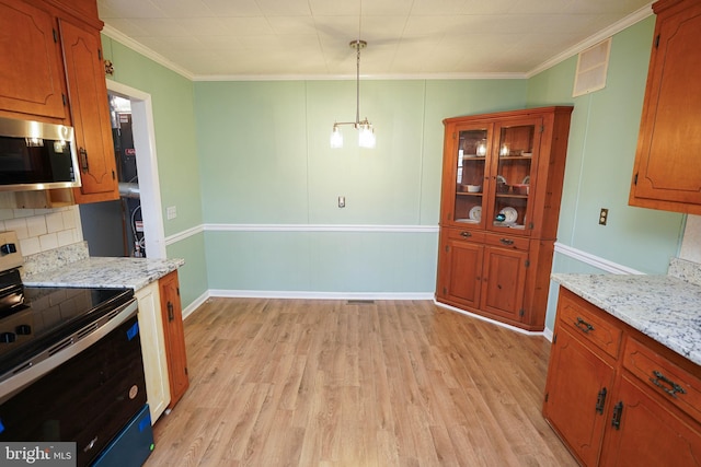 kitchen featuring light stone countertops, ornamental molding, stainless steel appliances, light hardwood / wood-style floors, and hanging light fixtures