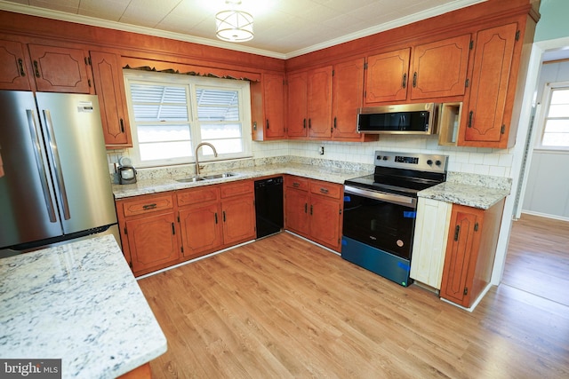 kitchen with tasteful backsplash, stainless steel appliances, crown molding, sink, and light hardwood / wood-style flooring