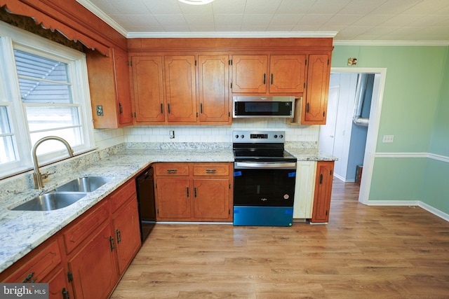 kitchen with backsplash, crown molding, sink, light hardwood / wood-style flooring, and stainless steel appliances