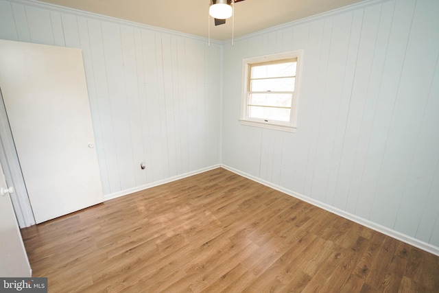 unfurnished room with ceiling fan, hardwood / wood-style floors, and ornamental molding