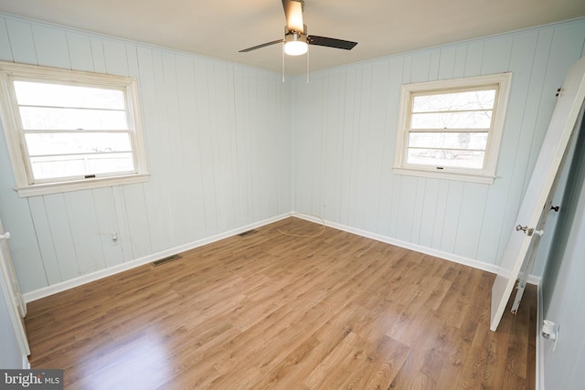 unfurnished room featuring light hardwood / wood-style flooring, plenty of natural light, and ceiling fan