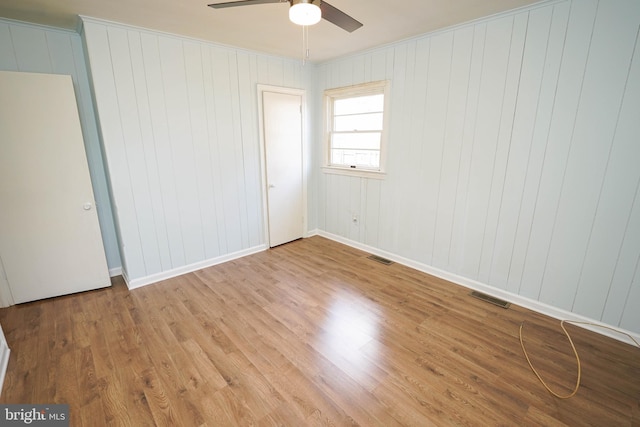 unfurnished bedroom with ceiling fan and light wood-type flooring