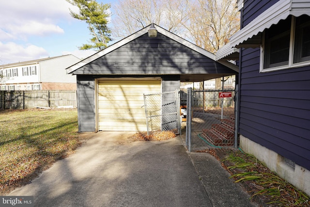 view of outbuilding featuring a lawn and a garage