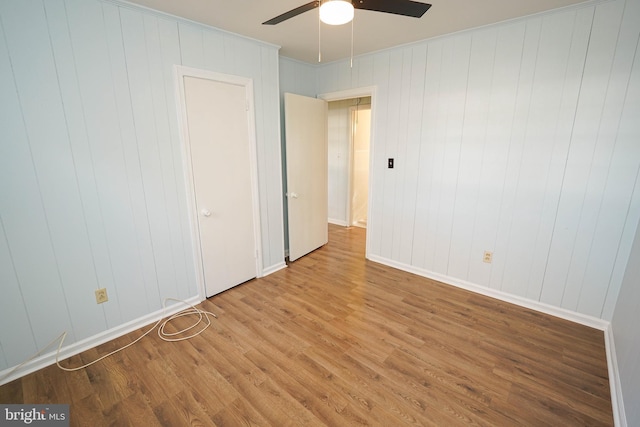 unfurnished bedroom with ceiling fan and light wood-type flooring