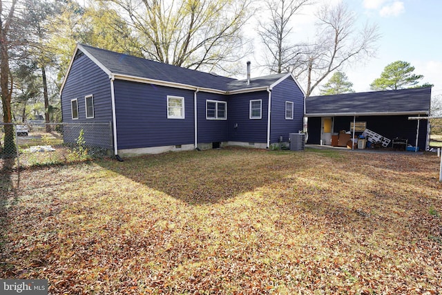 rear view of house with a yard and central AC unit