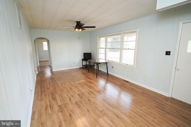 spare room with ceiling fan, light hardwood / wood-style flooring, and a healthy amount of sunlight