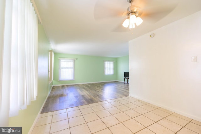 empty room featuring light wood-type flooring and ceiling fan