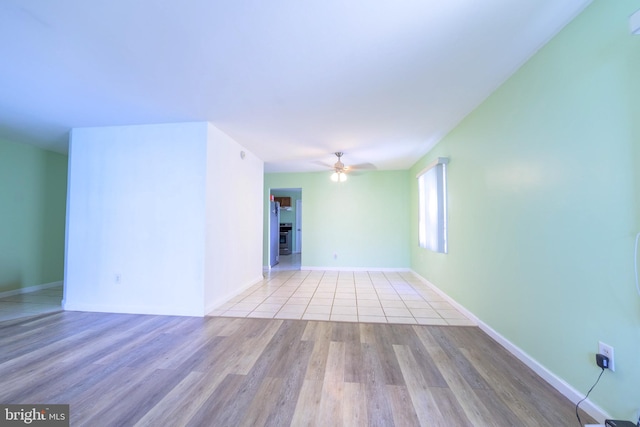 spare room with ceiling fan and light hardwood / wood-style floors