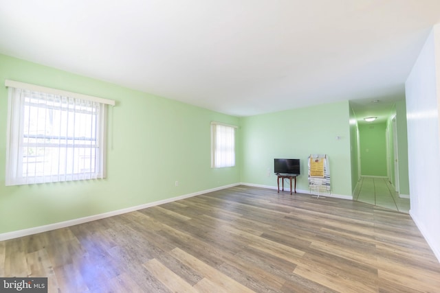 unfurnished living room with hardwood / wood-style flooring