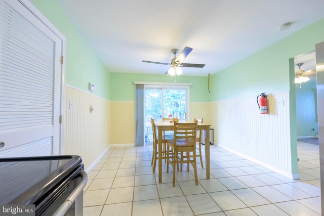 dining space with light tile patterned floors and ceiling fan