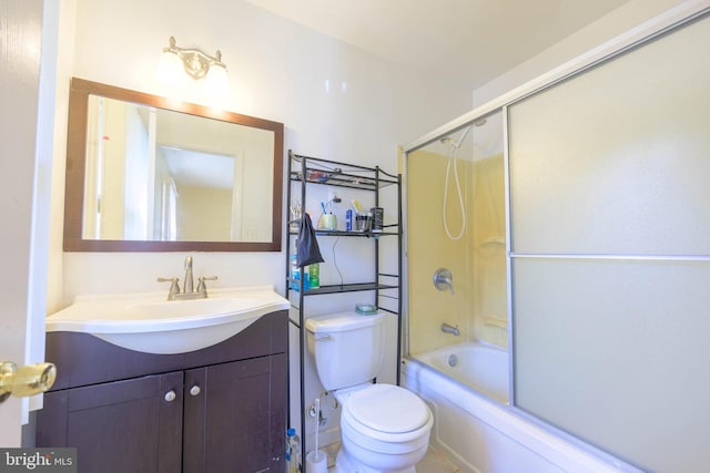 full bathroom featuring enclosed tub / shower combo, vanity, and toilet