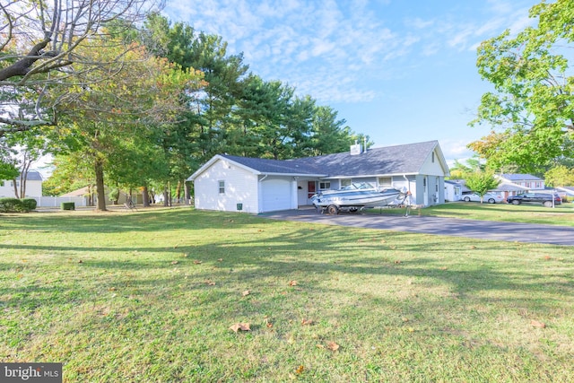 exterior space featuring a garage and a front lawn