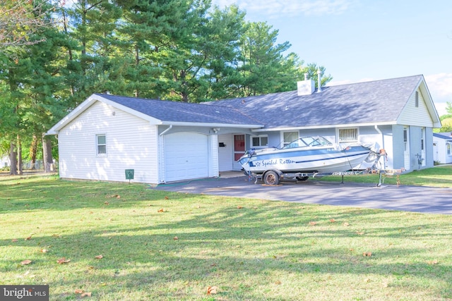 view of front of house featuring a garage and a front lawn